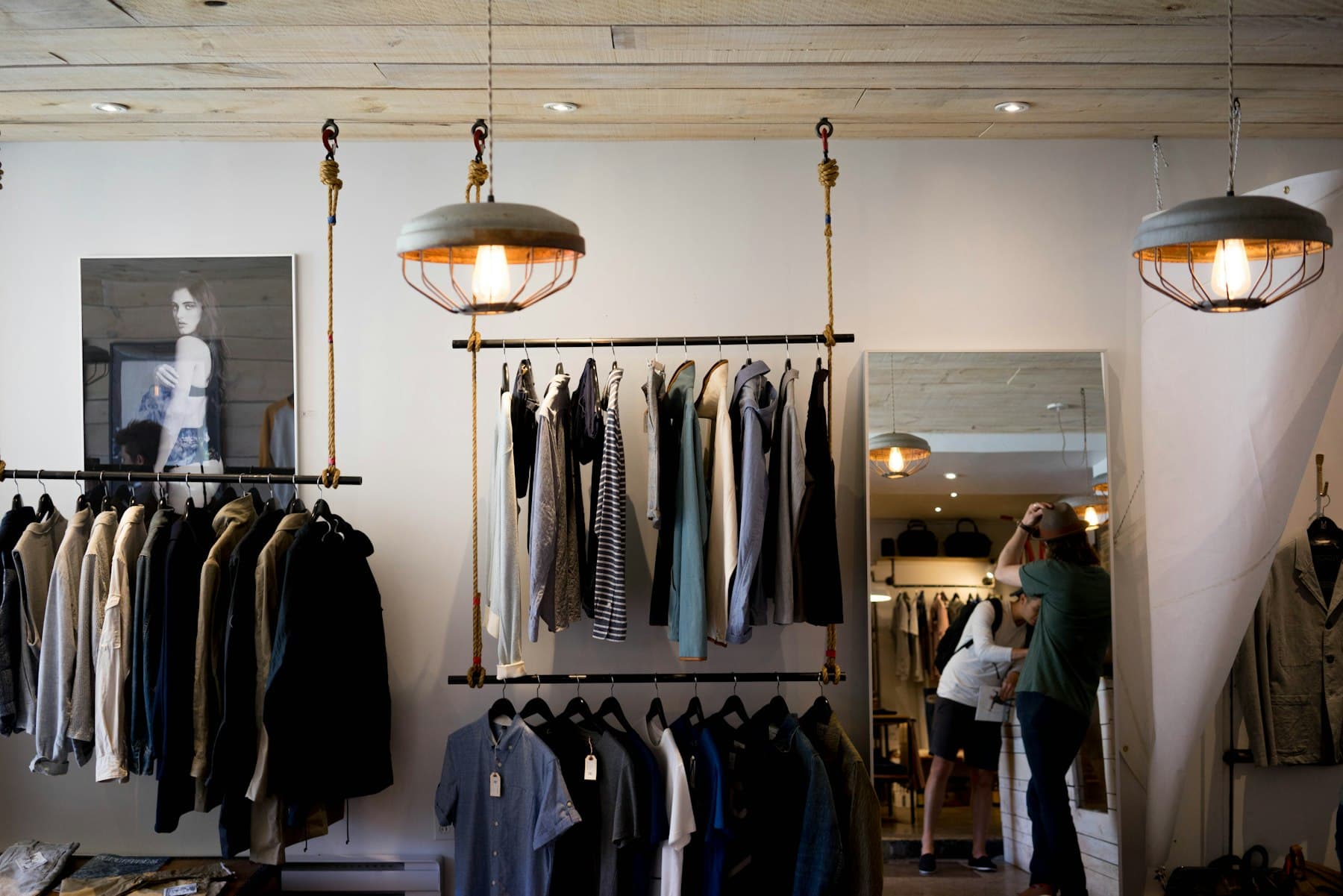 Boutique interior with clothing racks and pendant lamps